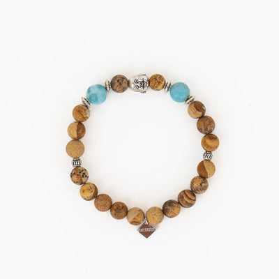 Bracelet fabriqué à la main avec de vrai pierres naturelles de Jaspe paysage et deux perles de Larimar de République Dominicaine. Bijou avec une tête de Bouddha et des intercalaires de couleur argent avec une breloque estampillée Orparima.