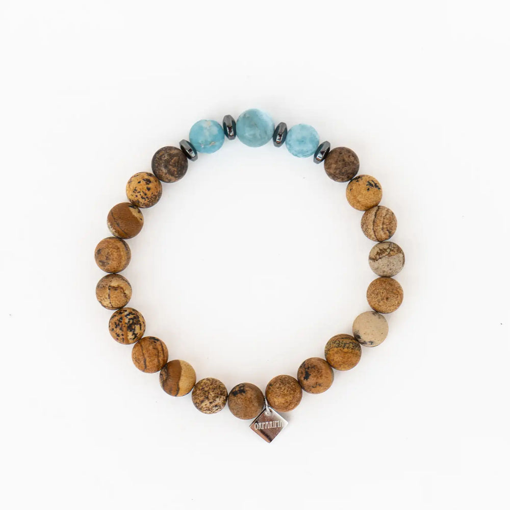 Bracelet constitué de pierres naturelles de Jaspes paysages et trois perles de Larimar de République Dominicaine. Bracelet élastique fait à la main.