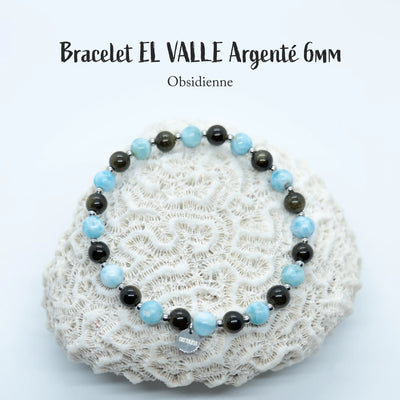Bijou fait à la main en République Dominicaine. Bracelet avec des perles d'obsidienne et de Larimar montées sur un fil élastique.