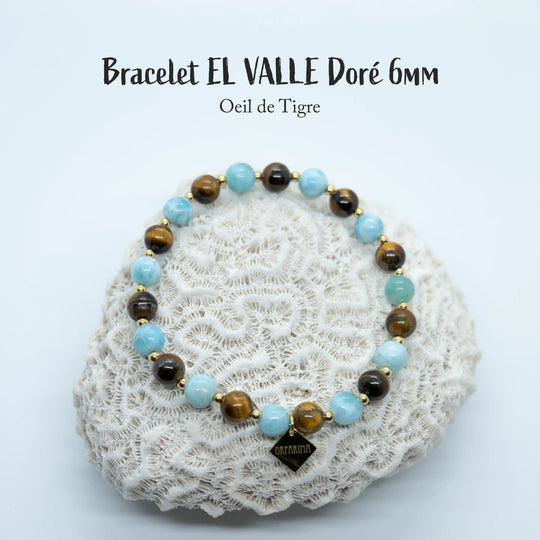 Bracelet en œil du tigre et en Larimar avec des perles de 6mm de diamètre, monté avec un fil élastique avec des petites perles en acier inoxydable 316L doré séparant chaque perles du bracelet.