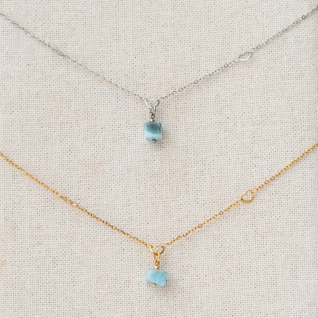 Deux colliers en acier inoxydable, l'un couleur argenté et l'autre couleur doré, avec un pendentif en Larimar de République Dominicaine. Le Larimar est de couleur bleu, c'est une pierre naturelle unique au monde.