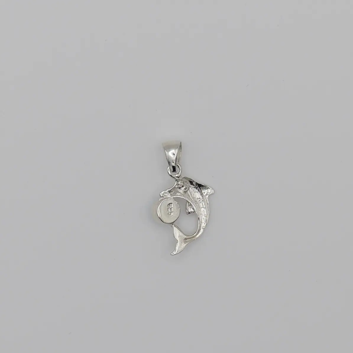 Pendentif en argent 925 en forme de dauphin avec une bélière pour être monté en collier avec une chaîne ou un cordon.